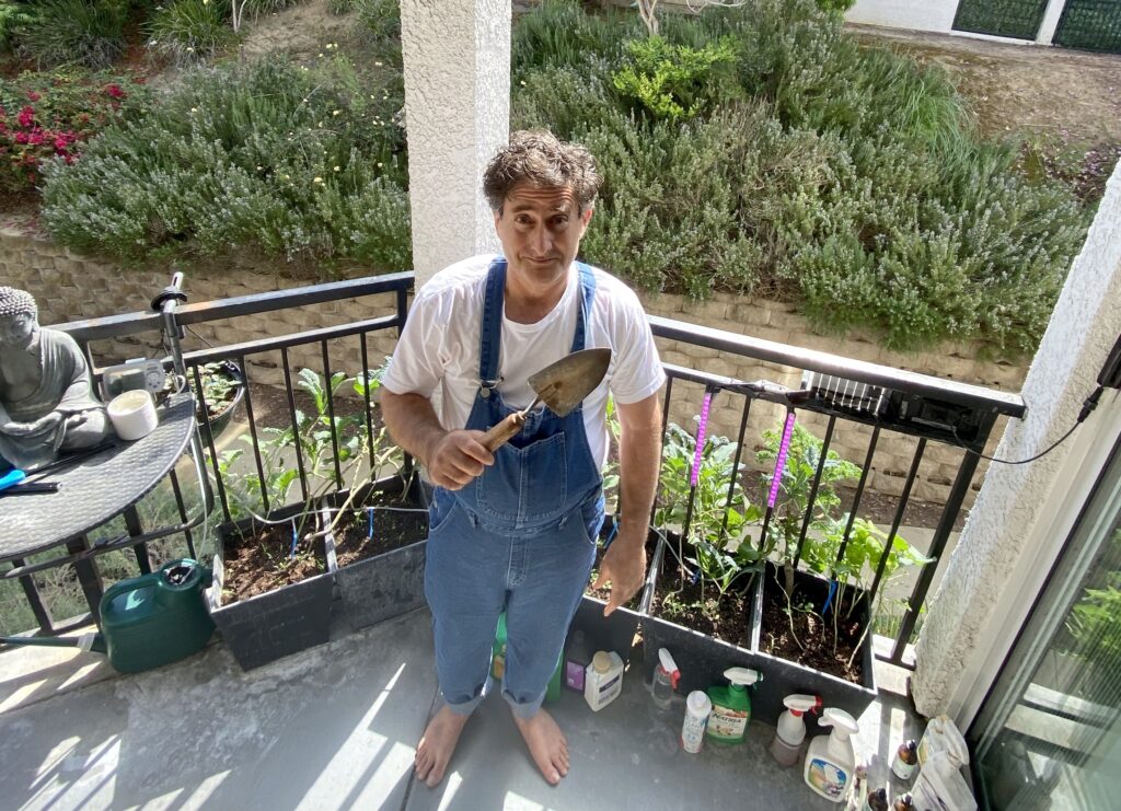 Corey Levitan, his balcony bounty, and the overalls he returned to Amazon after this photo op.