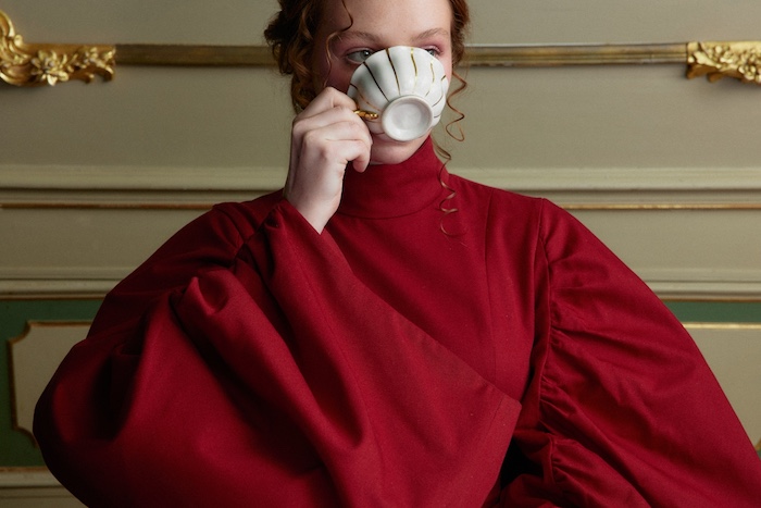 Woman in red drinking tea