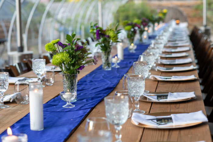 Long communal table set outside for dinner service