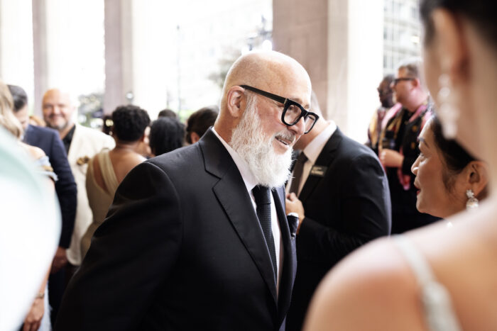 Chef Andrew Zimmern, host of the 2026 James Beard Awards, speaks with guests on the red carpet before the ceremony. Zimmern praised the awards' growing recognition of diverse cuisines, independent operators, and regional culinary traditions.