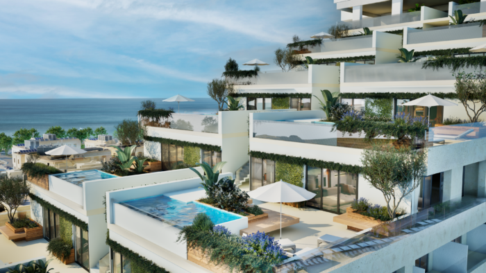 A rendering of the Rock Suite at Hard Rock Hotel Malta showcases a collection of contemporary terraced residences cascading toward the Mediterranean Sea. Spacious private terraces feature infinity-edge pools, lounge areas, sun umbrellas and lush landscaping with trees, flowering plants and greenery integrated throughout the architecture. Floor-to-ceiling glass walls connect indoor and outdoor living spaces, while the stepped design maximizes ocean views and natural light, creating a luxurious resort-style coastal setting.