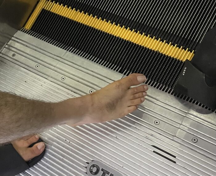 Bare foot beside the escalator where a slide became caught at Los Cabos International Airport.