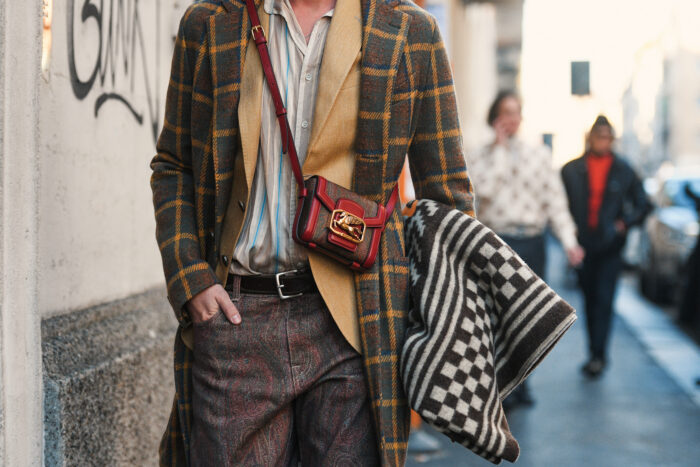 Milan, Italy – January 12, 2020: Fashionable man with Etro purse, street style outfit.