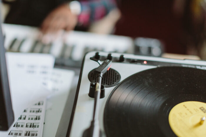 Close-up of a turntable playing a vinyl record in a record shop.